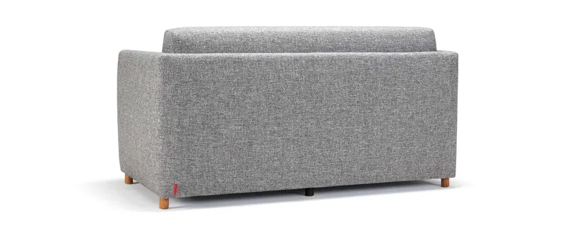 Das OLAN Schlafsofa mit Polsterarmlehnen kann auch freistehend im Raum genutzt werden